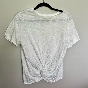 White t-shirt with cute knot front. Fits like a small.